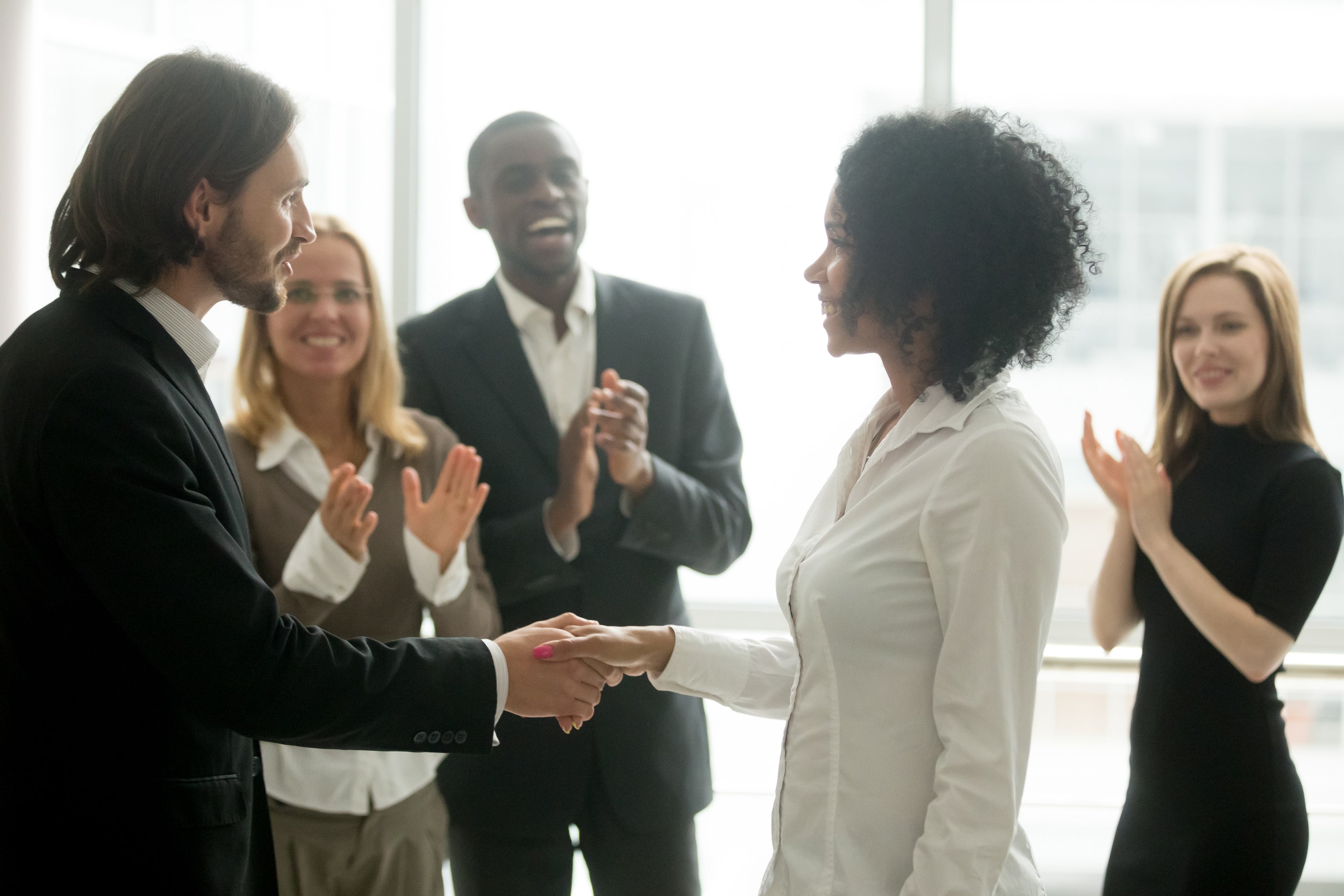 Leader celebrating success with a team, representing the impact of effective value stream improvements.