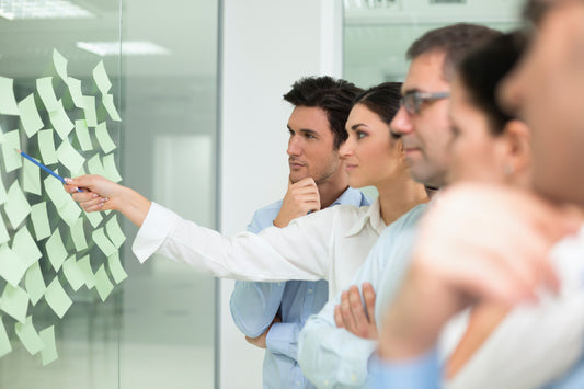 Colorful sticky notes on a board, showcasing brainstorming and problem-solving in action.