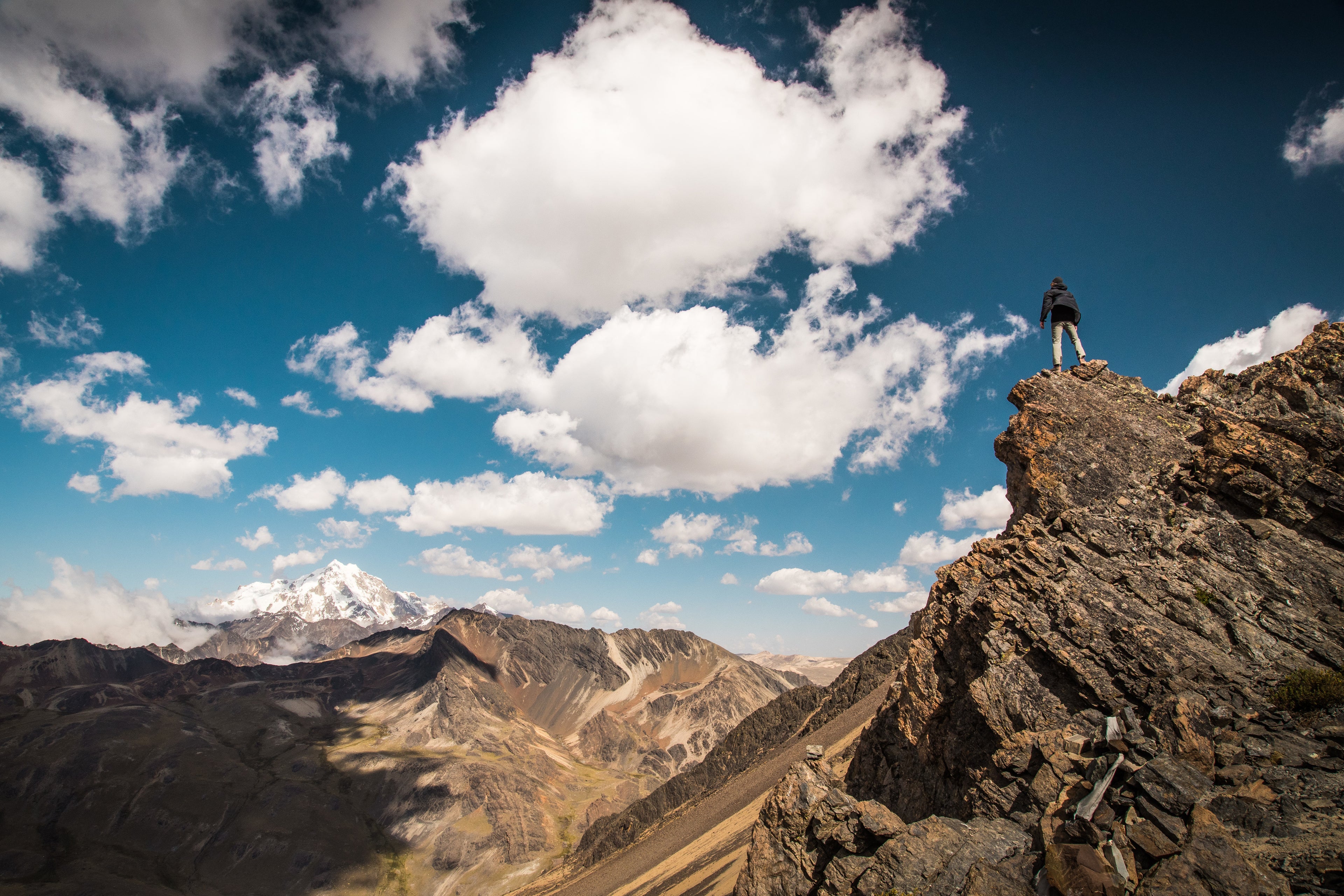 Man climbing rocks, symbolizing the challenge and achievement of advancing your career with Lean Six Sigma certification.