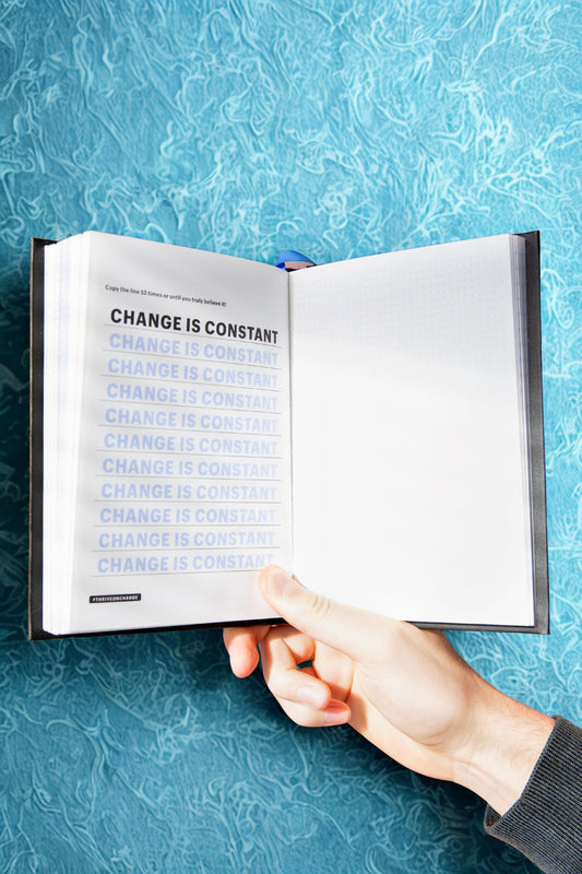 Notebook with a reminder that 'change is constant,' symbolizing the importance of adaptability and leadership in managing change.