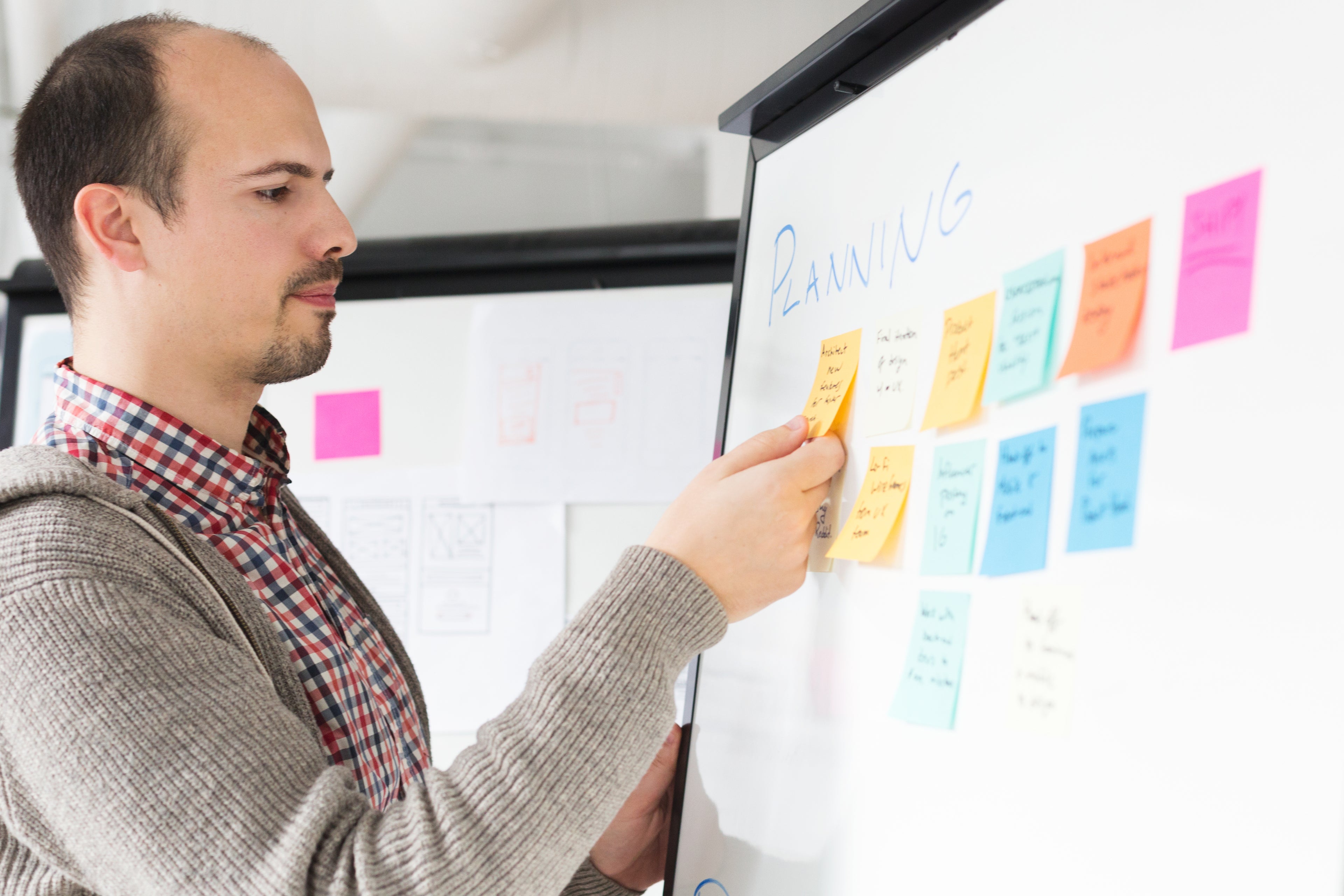 Team collaborating on a software development plan, symbolizing real-world applications of Lean or Lean Six Sigma tools.